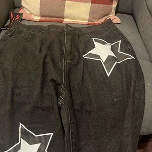 Junior black jeans with white stars and the jeans are a L